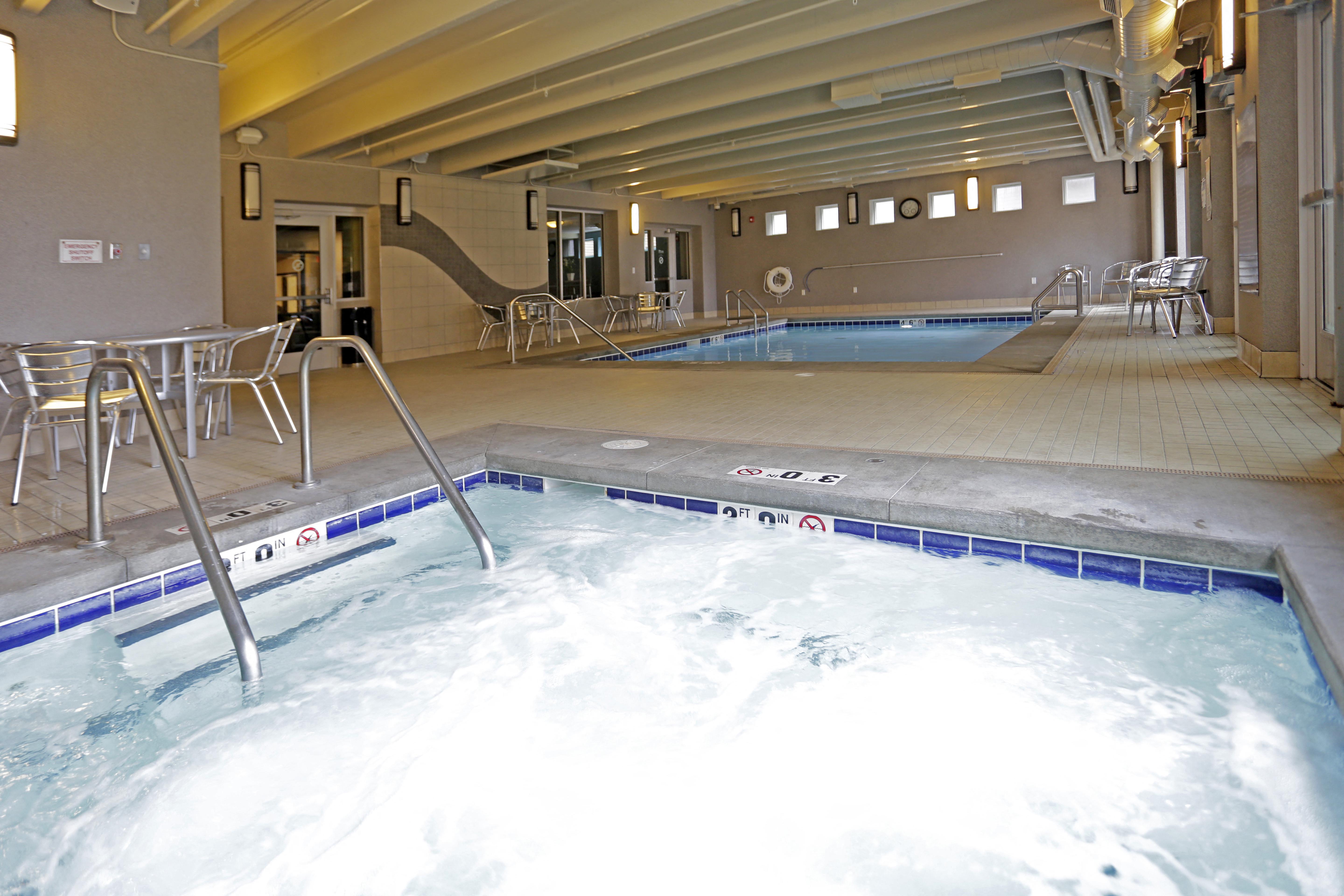 Angled view of the indoor hot tub and pool at River Ridge Apartment Homes.